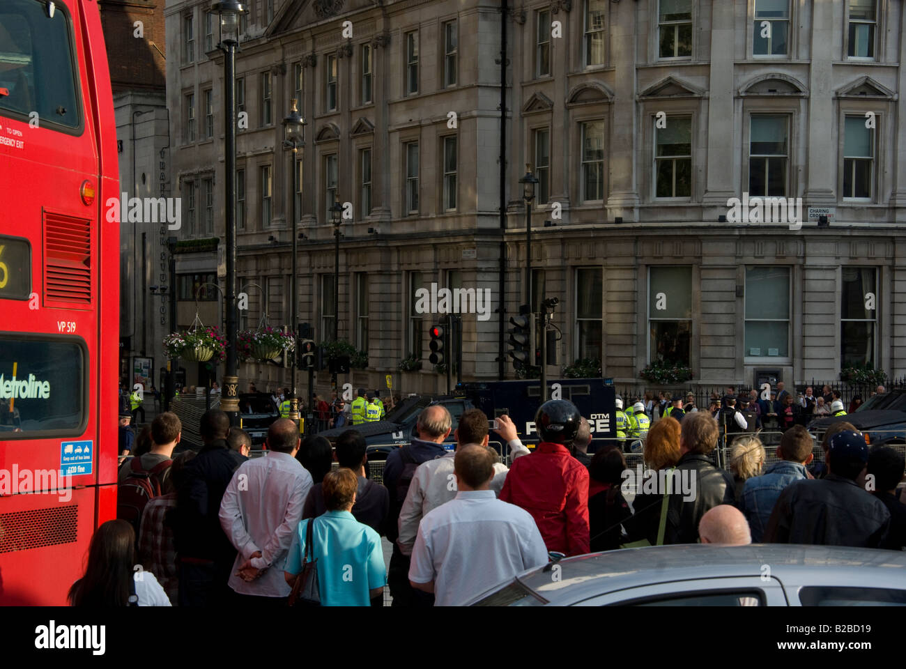 People photographing the police roadblock and polices waiting for Bush car convoy Stock Photo