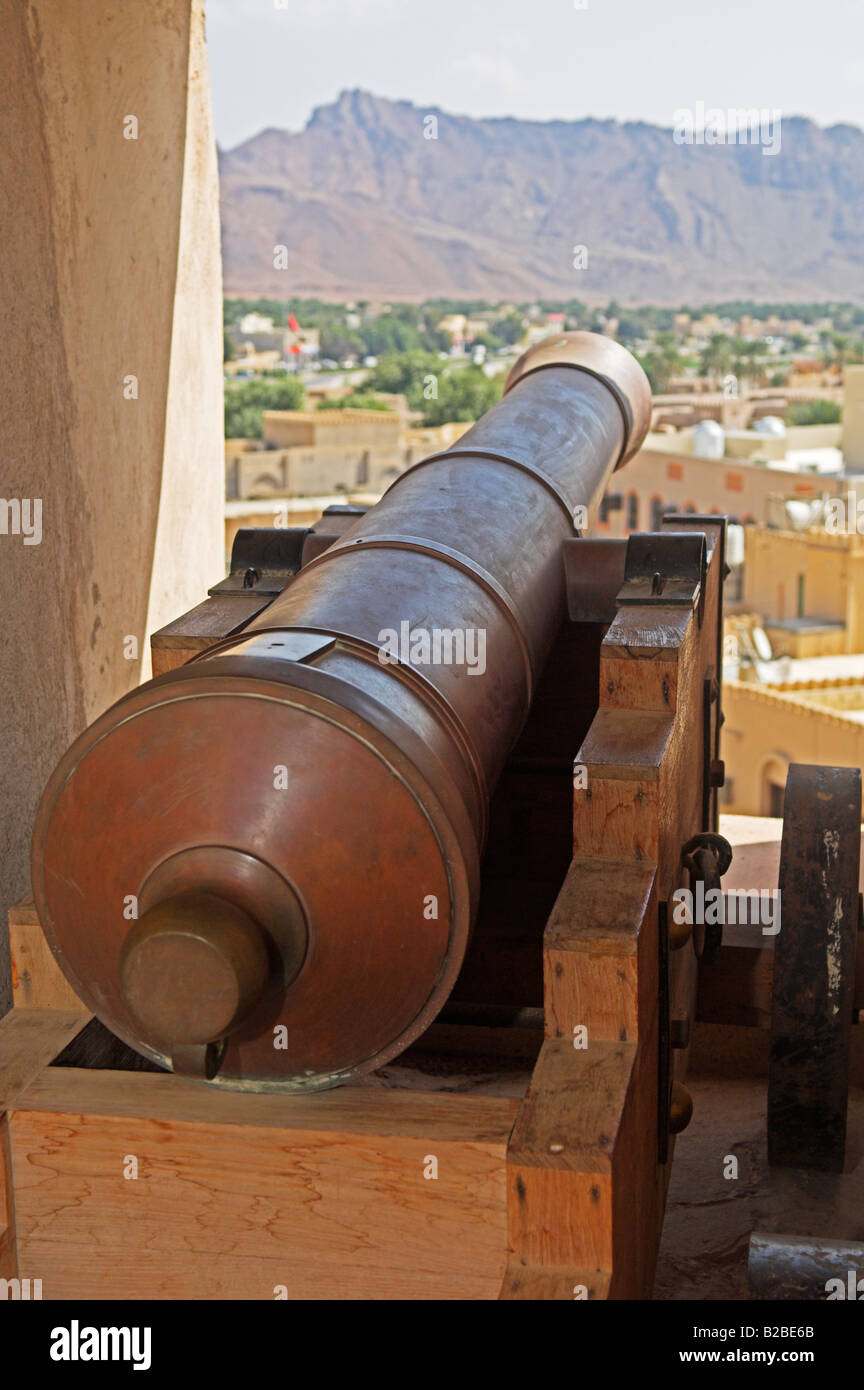 Bronze cannon looking out from Nezwa fort over distant mountains Oman Stock Photo