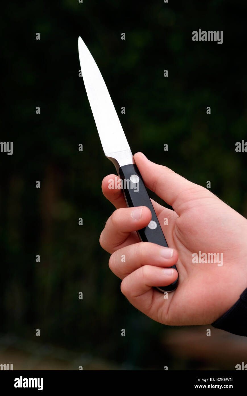 Knife crime boys hand holding a kitchen knife Stock Photo Alamy