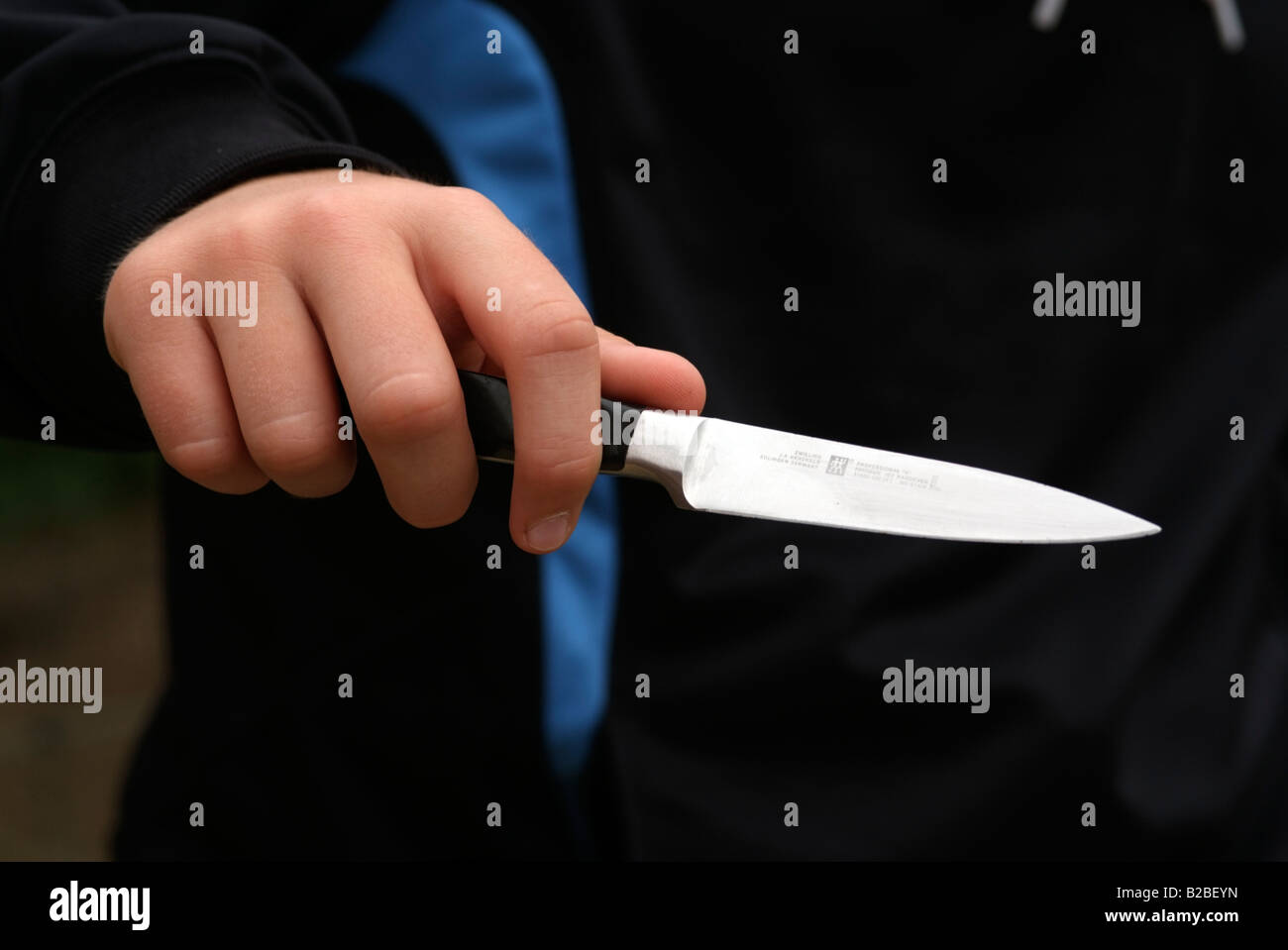 Knife crime. Boys hand holding a kitchen knife Stock Photo Alamy