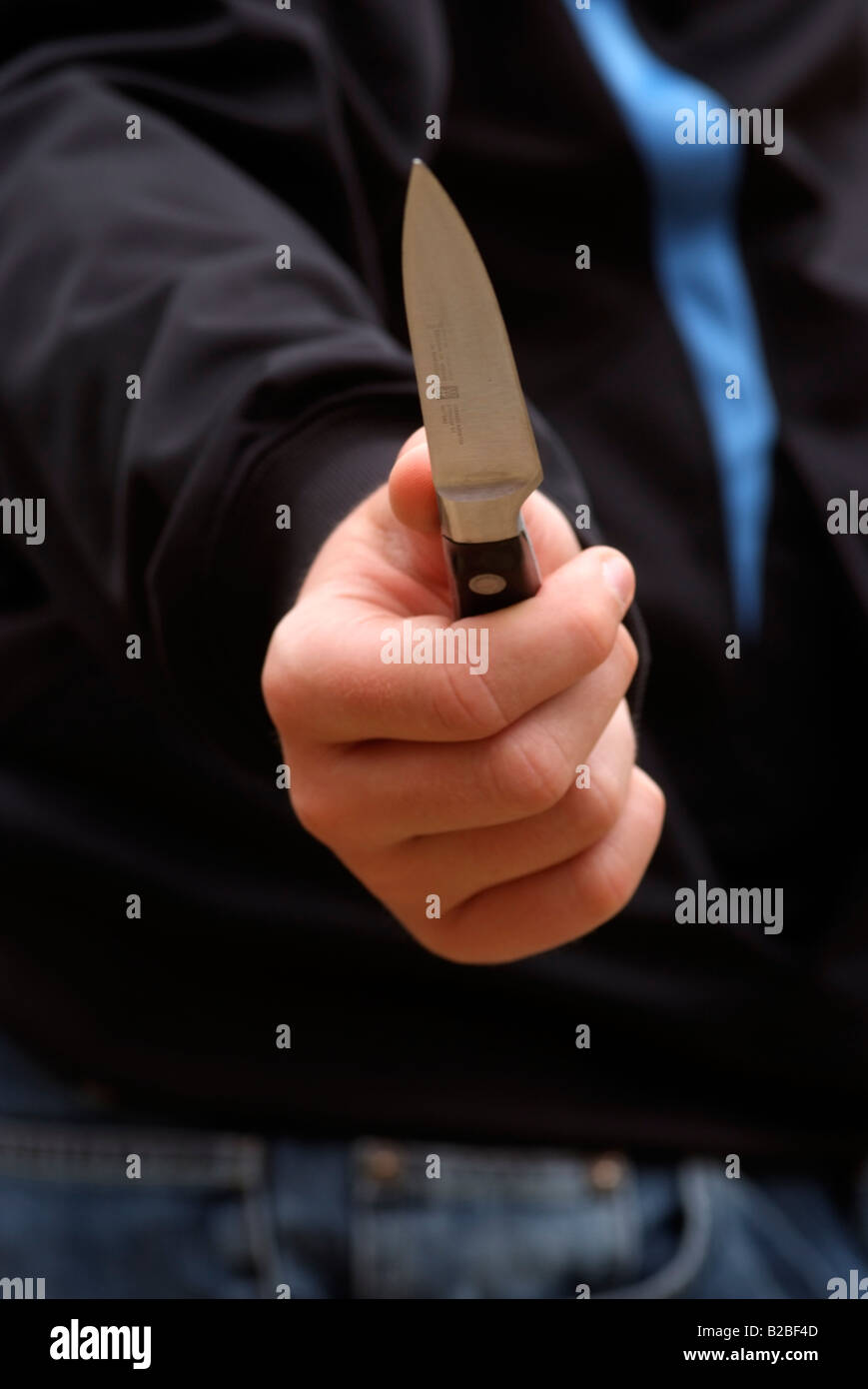 Knife crime boys hand holding a kitchen knife Stock Photo Alamy