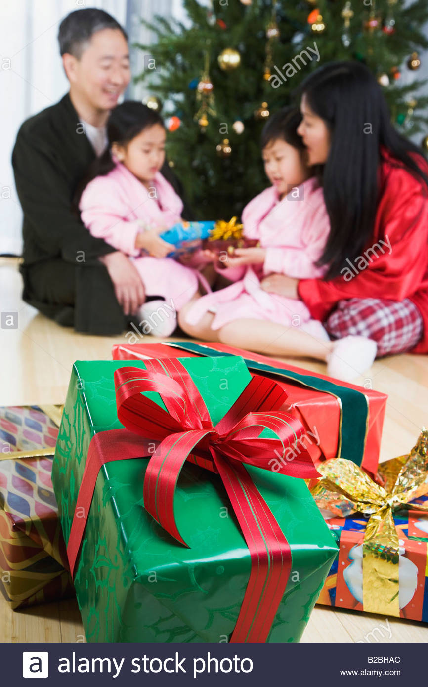 Asian family opening Christmas presents Stock Photo: 18694772 - Alamy