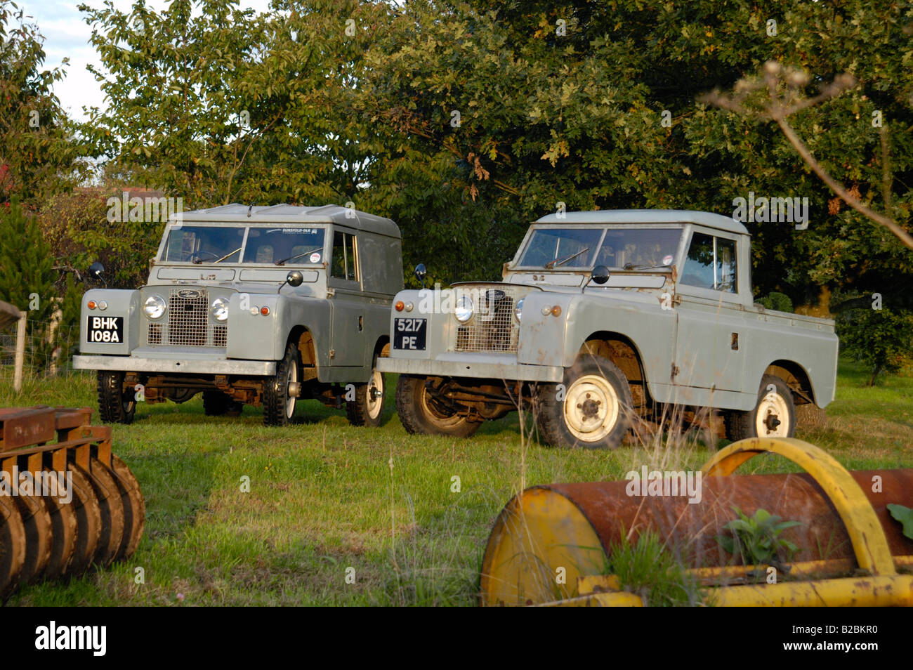 A matching couple of two historic 1963 Landrover Series 2a's on a farm in Dunsfold, UK 2004. Stock Photo