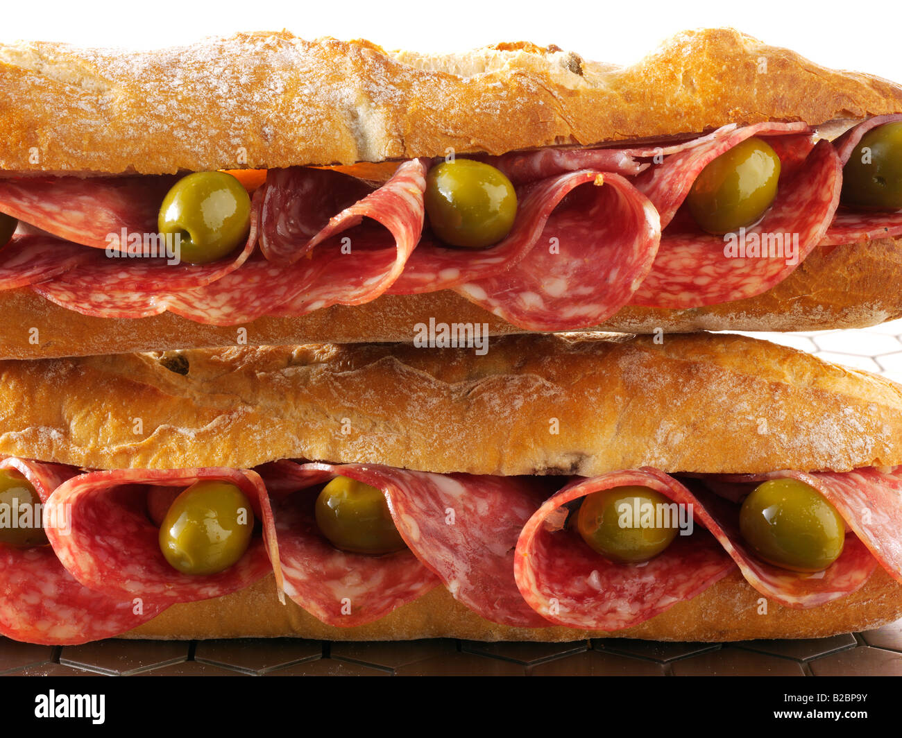 close up of salami and olives baguette in french bread stick Stock Photo