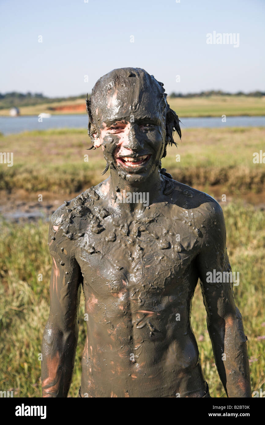 Boy covered in mud after playing in mud pool Stock Photo Alamy
