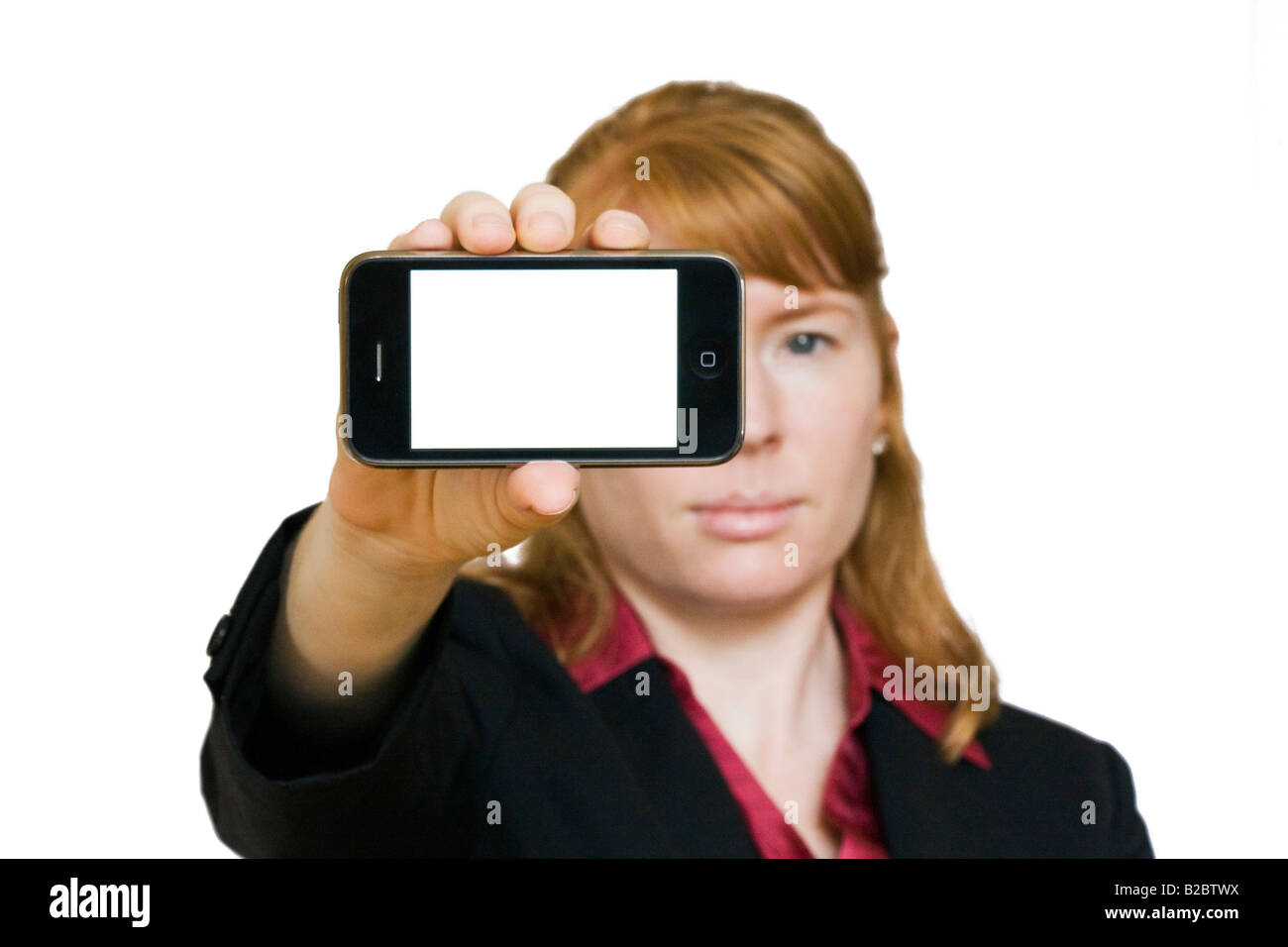 A female model holds up a new Apple 3G iPhone with a blank screen Stock Photo
