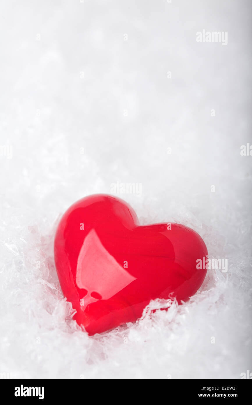 Red glass heart on artificial snow Stock Photo