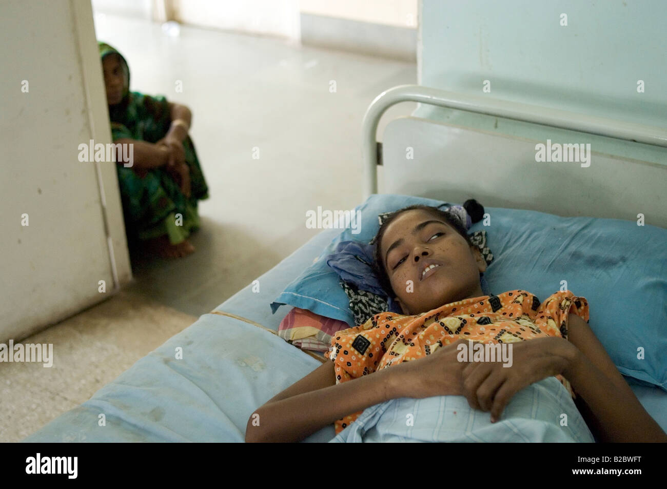 Girl, patient in the private Shree Jain Hospital, her stay funded by an aid organisation, critically ill with tuberculor mening Stock Photo