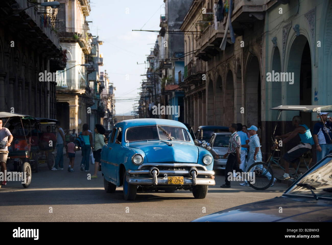 Busy street scene with old Amercan vintage car and colonial architecture in La Habana Vieja Havana Cuba Stock Photo