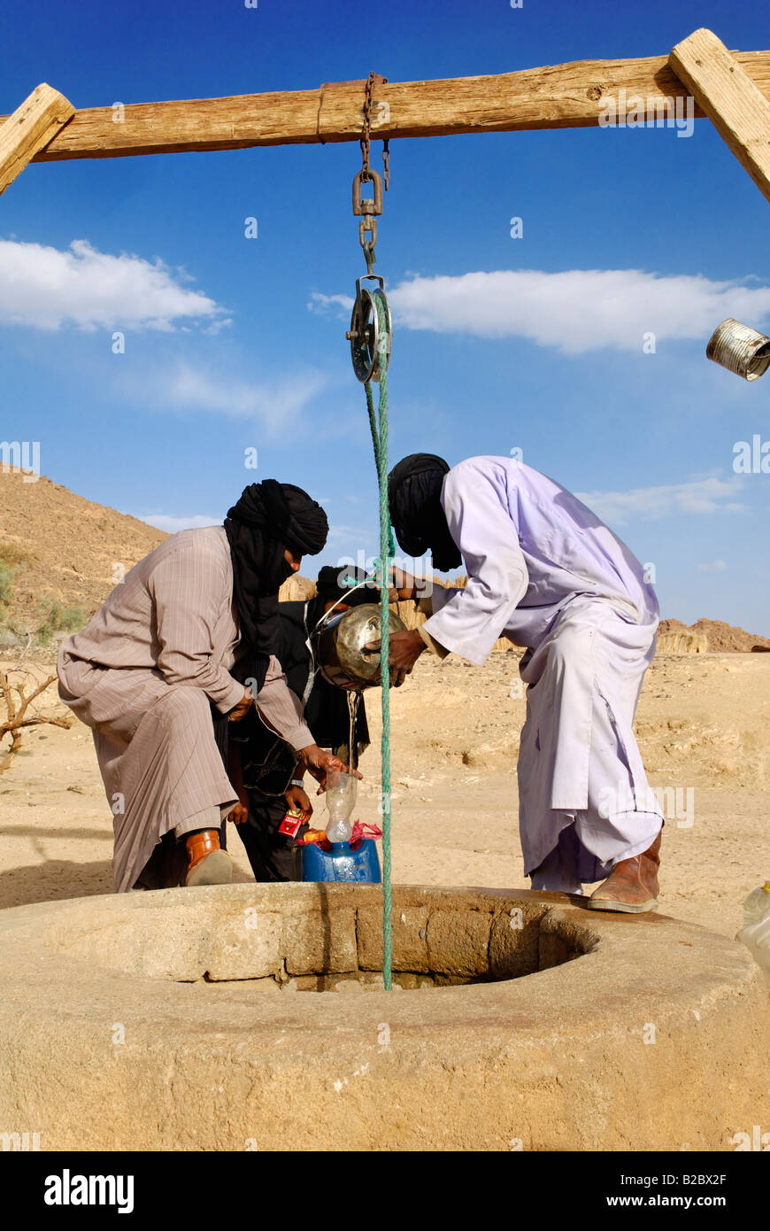 Tuareg people drawing water from a well, Wilaya Tamanrasset, Algeria, Sahara, North Africa Stock Photo