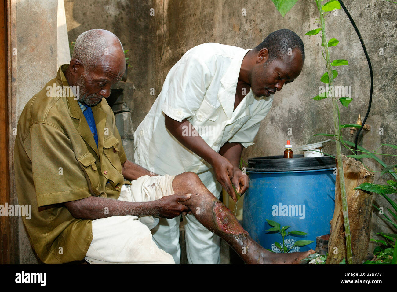 A natural healer treating the bad leg of a patient, Yaounde, Cameroon, Africa Stock Photo