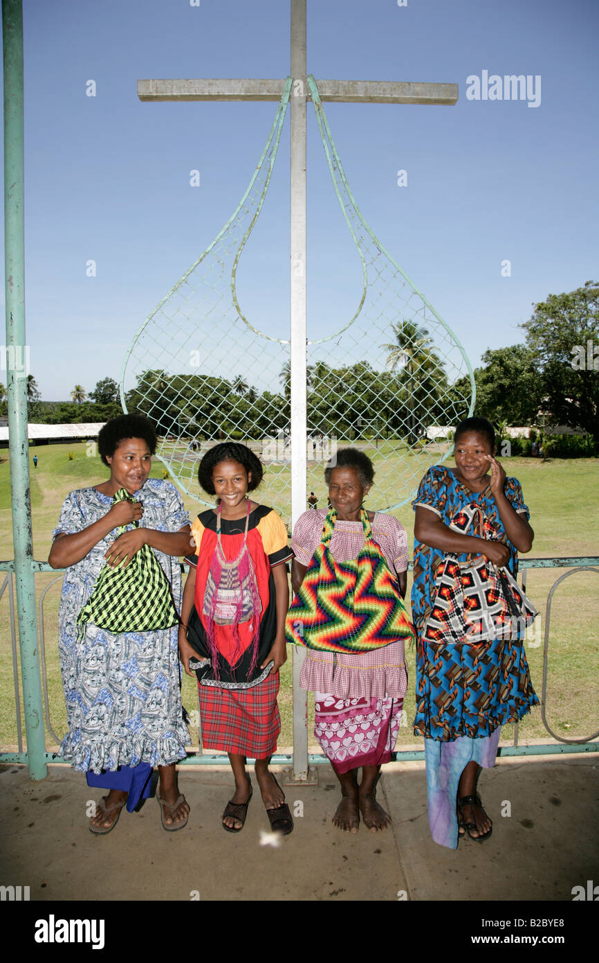 Women in front of cross and bilum string bags, typical bags in PNG, Madang, Papua New Guinea, Melanesia Stock Photo