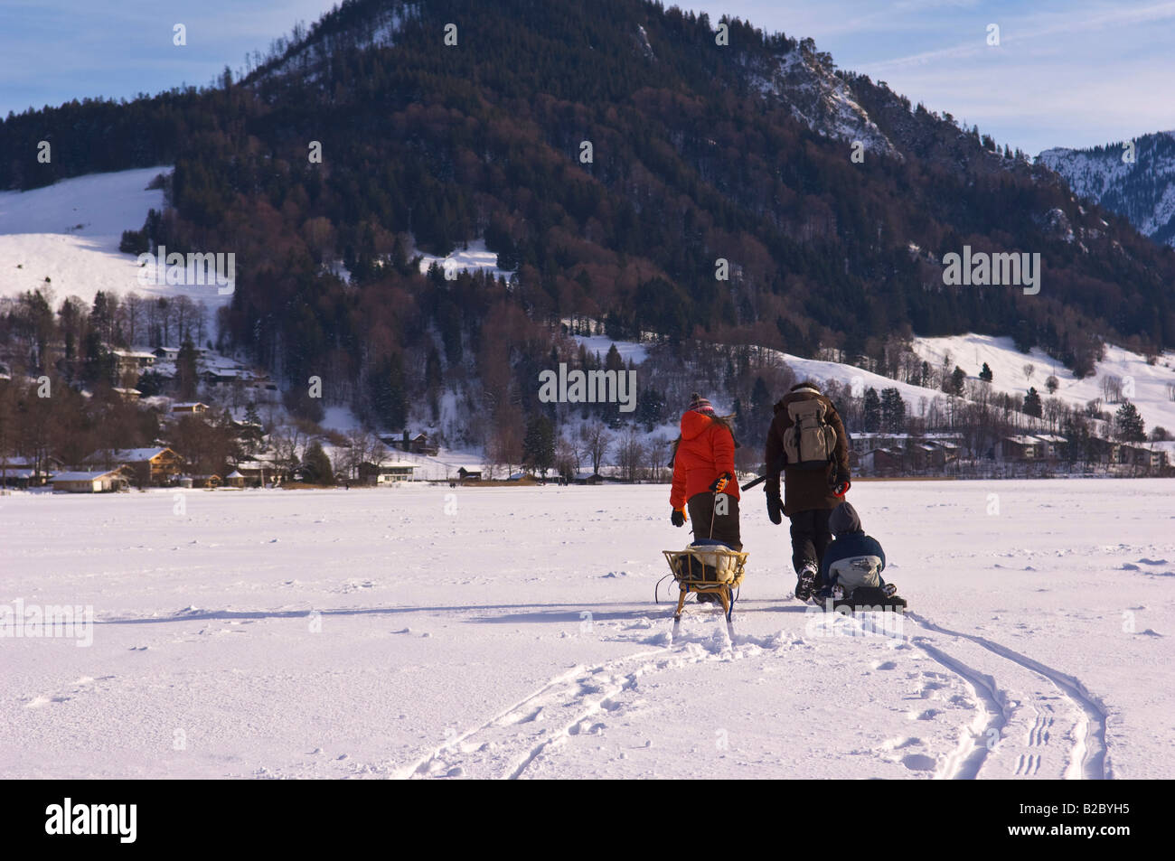 Hikers on the frozen Lake Schliersee, winter landscape, Bavaria, Germany, Europe Stock Photo
