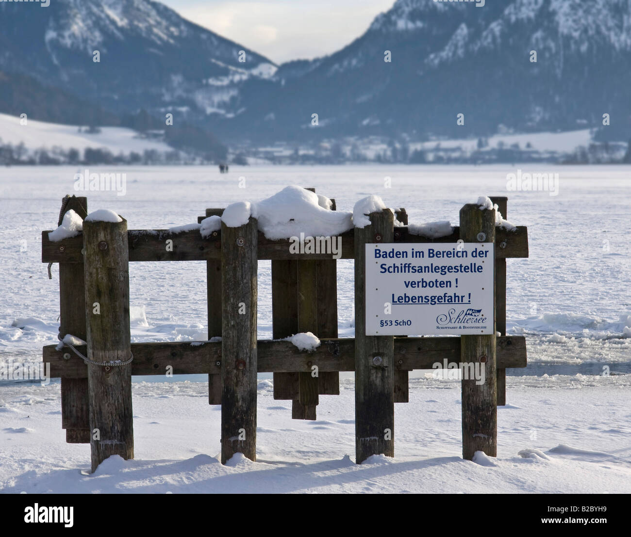 No Swimming warning sign next to the frozen over Lake Schliersee, winter landscape, Bavaria, Germany, Europe Stock Photo