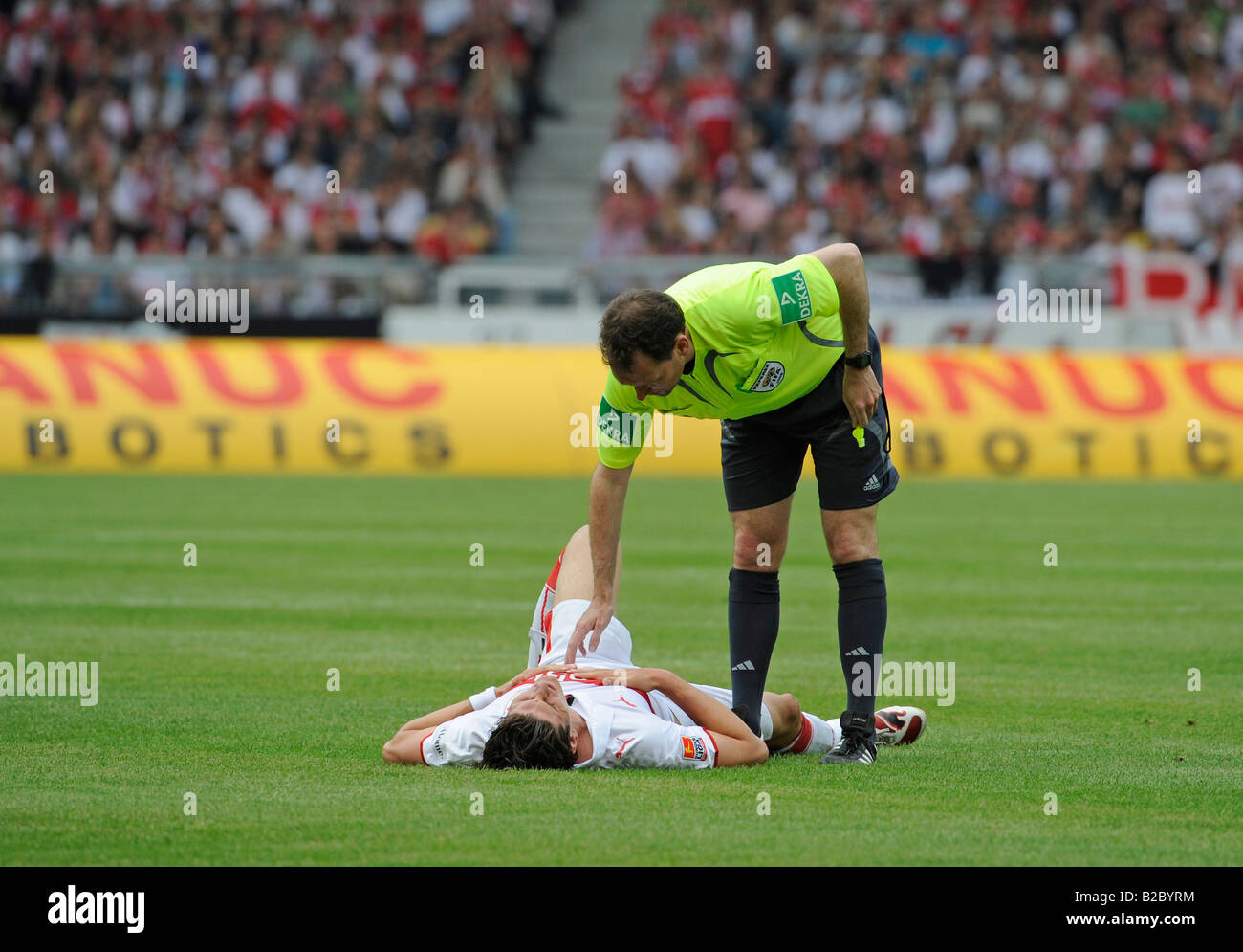 Referee Florian MEYER looking after the VfB Stuttgart footballer Mario GOMEZ, on the ground Stock Photo