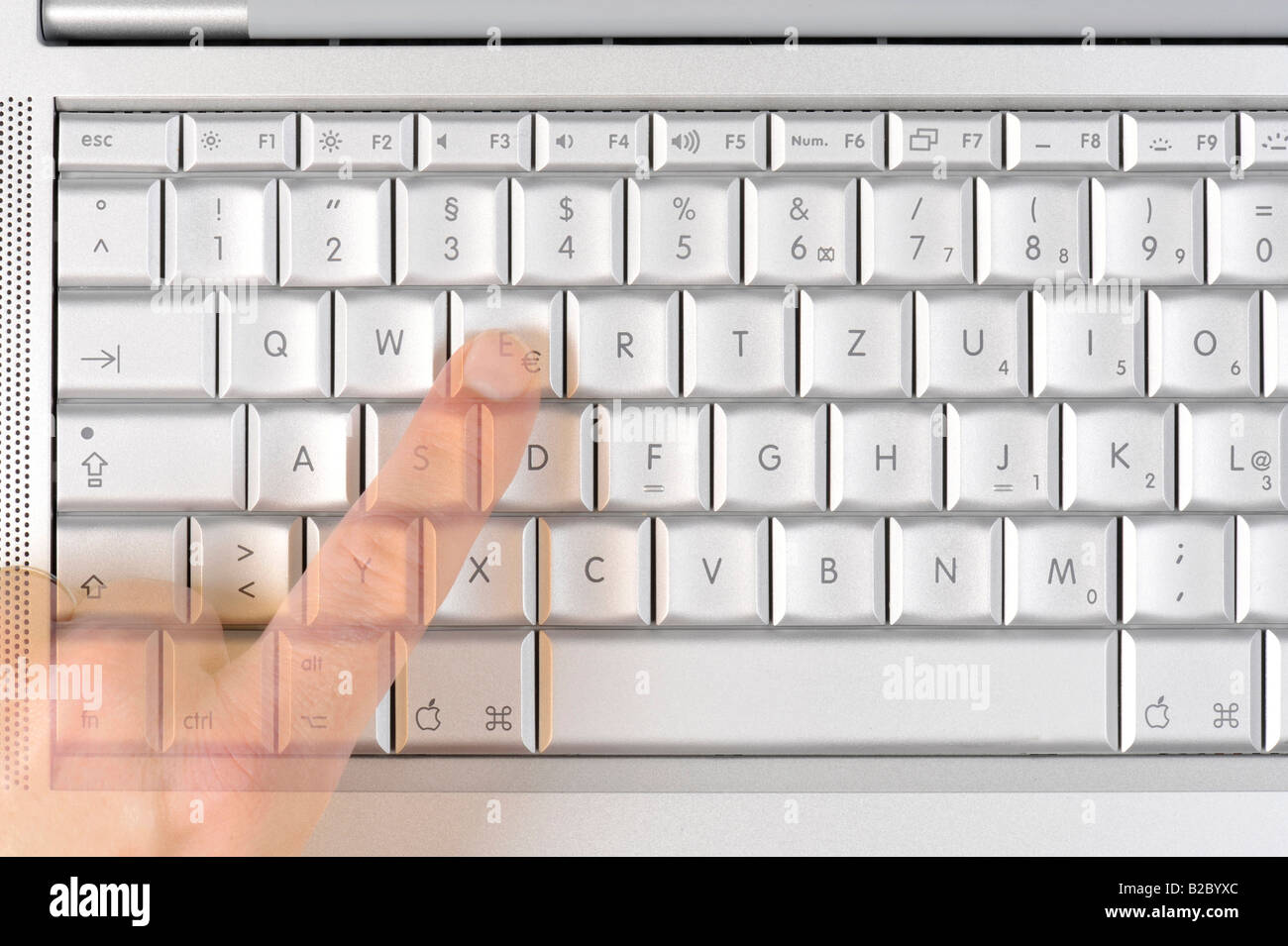 Apple MacBook Pro keyboard, one finger on the Euro symbol Stock Photo