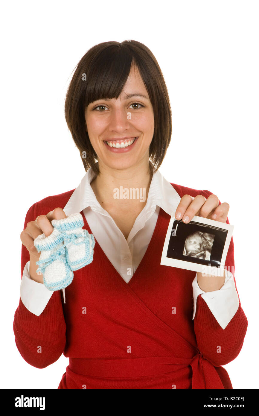 20-year-old woman holding booties and a sonogram Stock Photo - Alamy