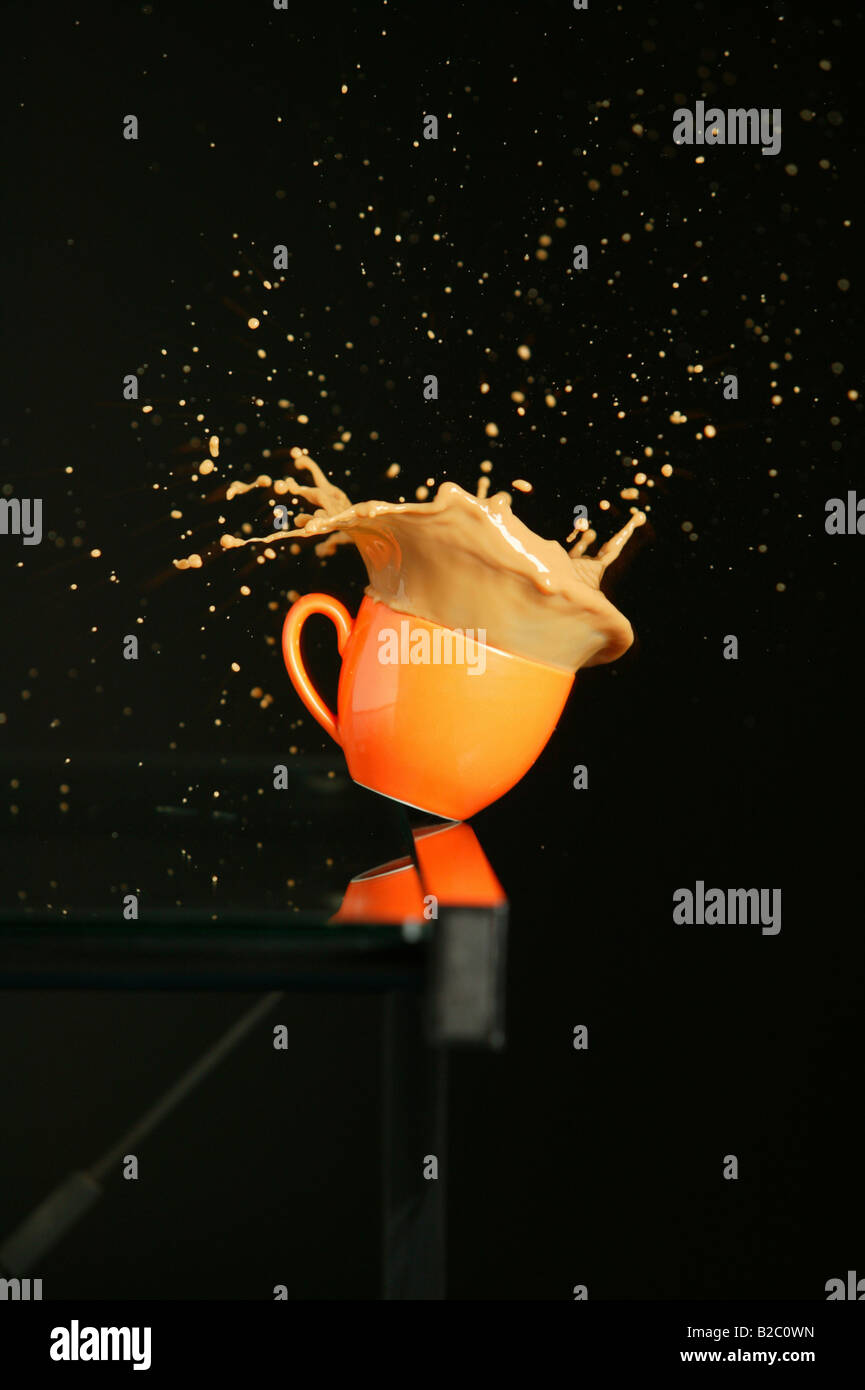 Coffe mug falling off the table Stock Photo Alamy