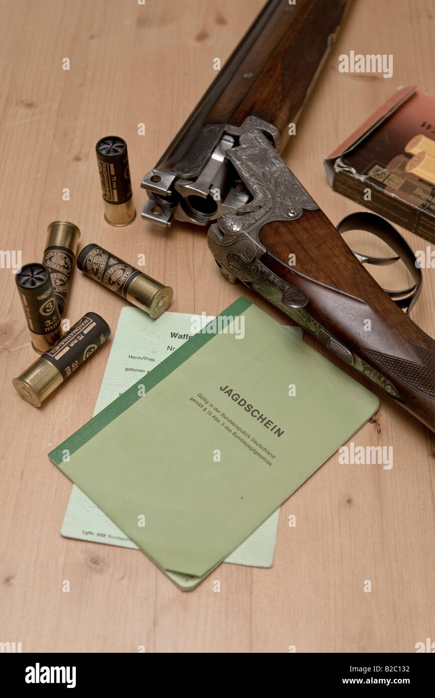 Hunting weapon, shotgun, long gun with engraving, shooting license and gun ownership license Stock Photo