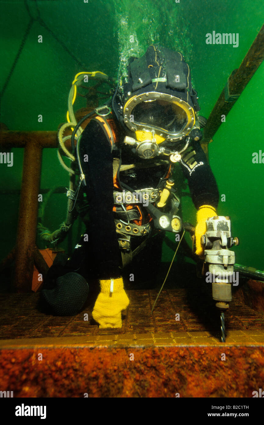 Professional off shore diver in training, drilling underwater, The