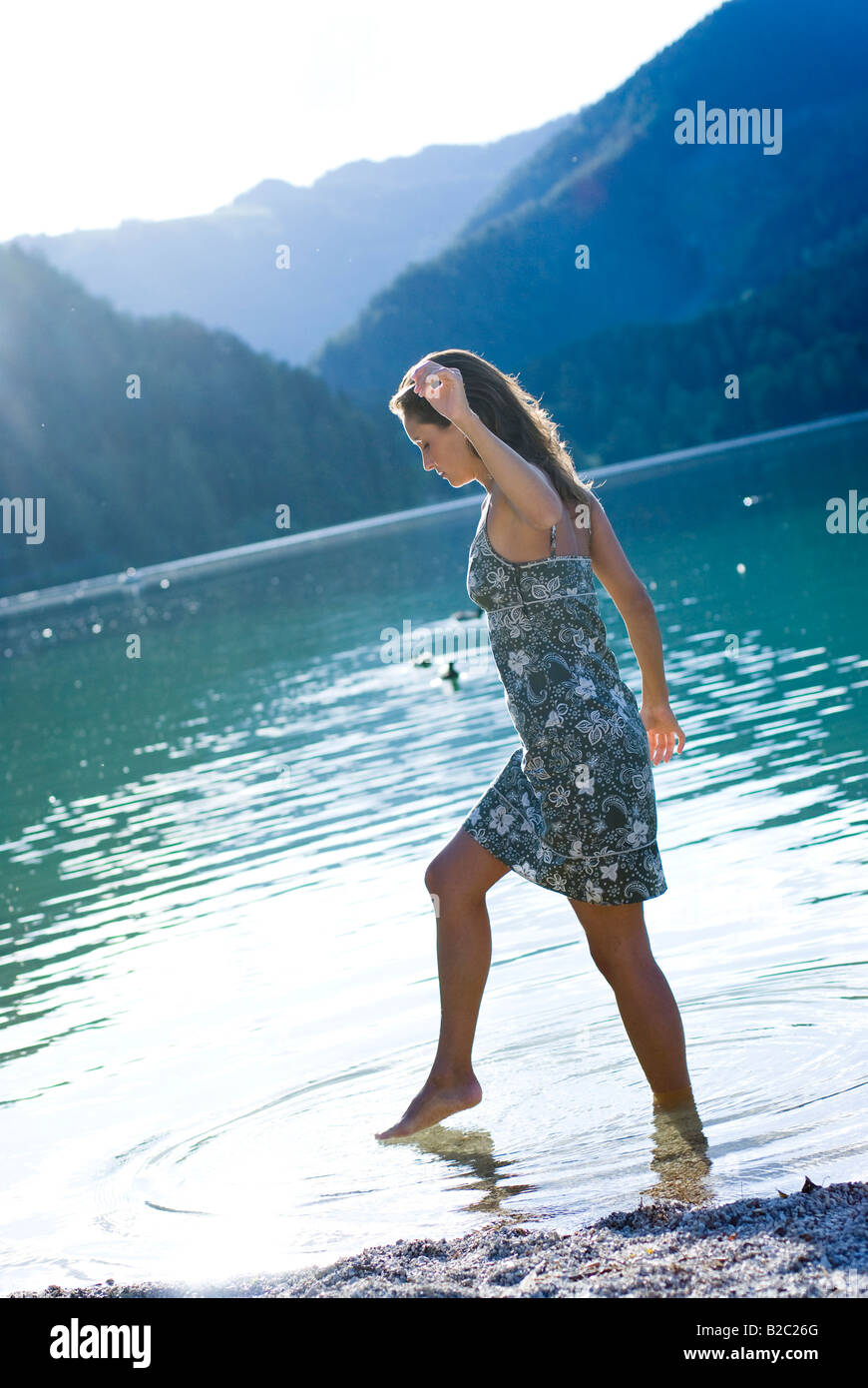 Woman wading in water in a dress hires stock photography and images