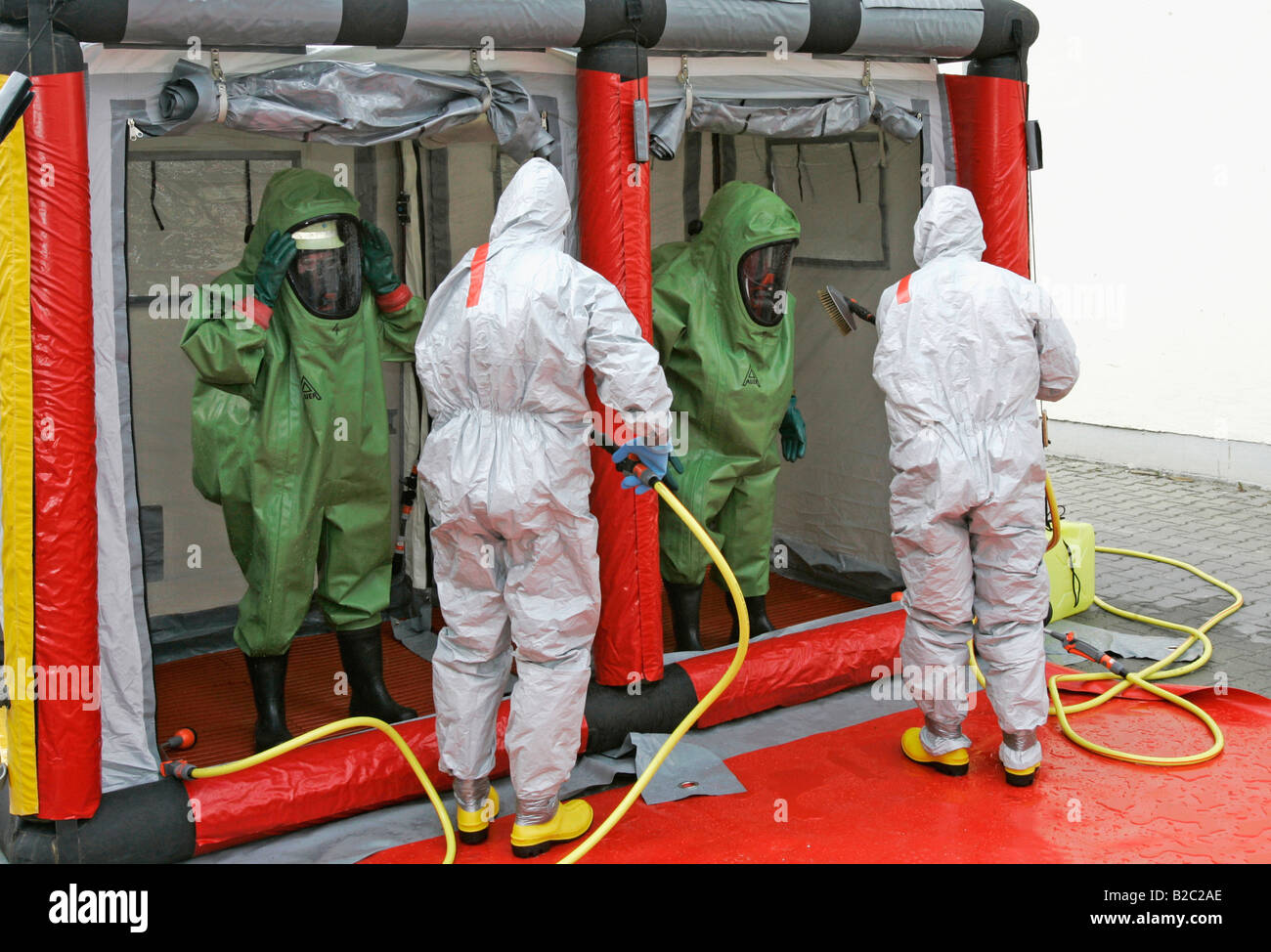 Fire brigade's mobile decontamination tent, firemen wearing hazmat suits at work during a disaster control drill, near Poing, B Stock Photo