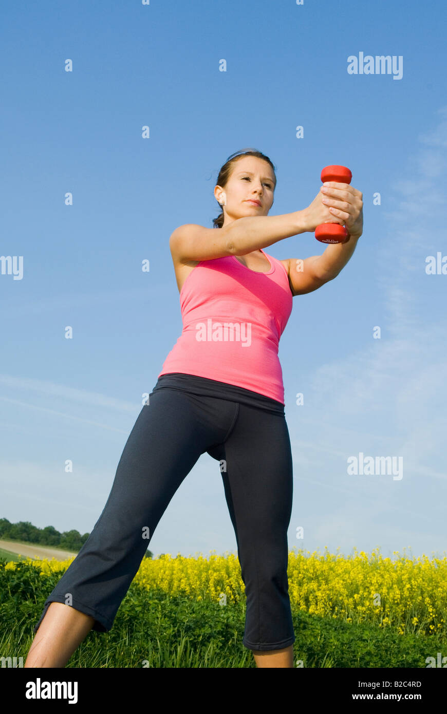 young woman lifting barbells outdoor Stock Photo Alamy