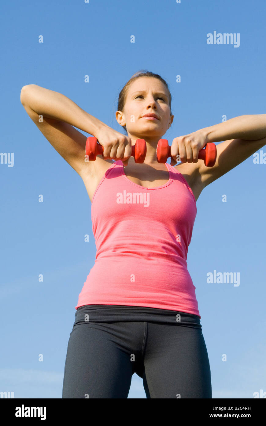 young woman lifting barbells outdoor Stock Photo Alamy