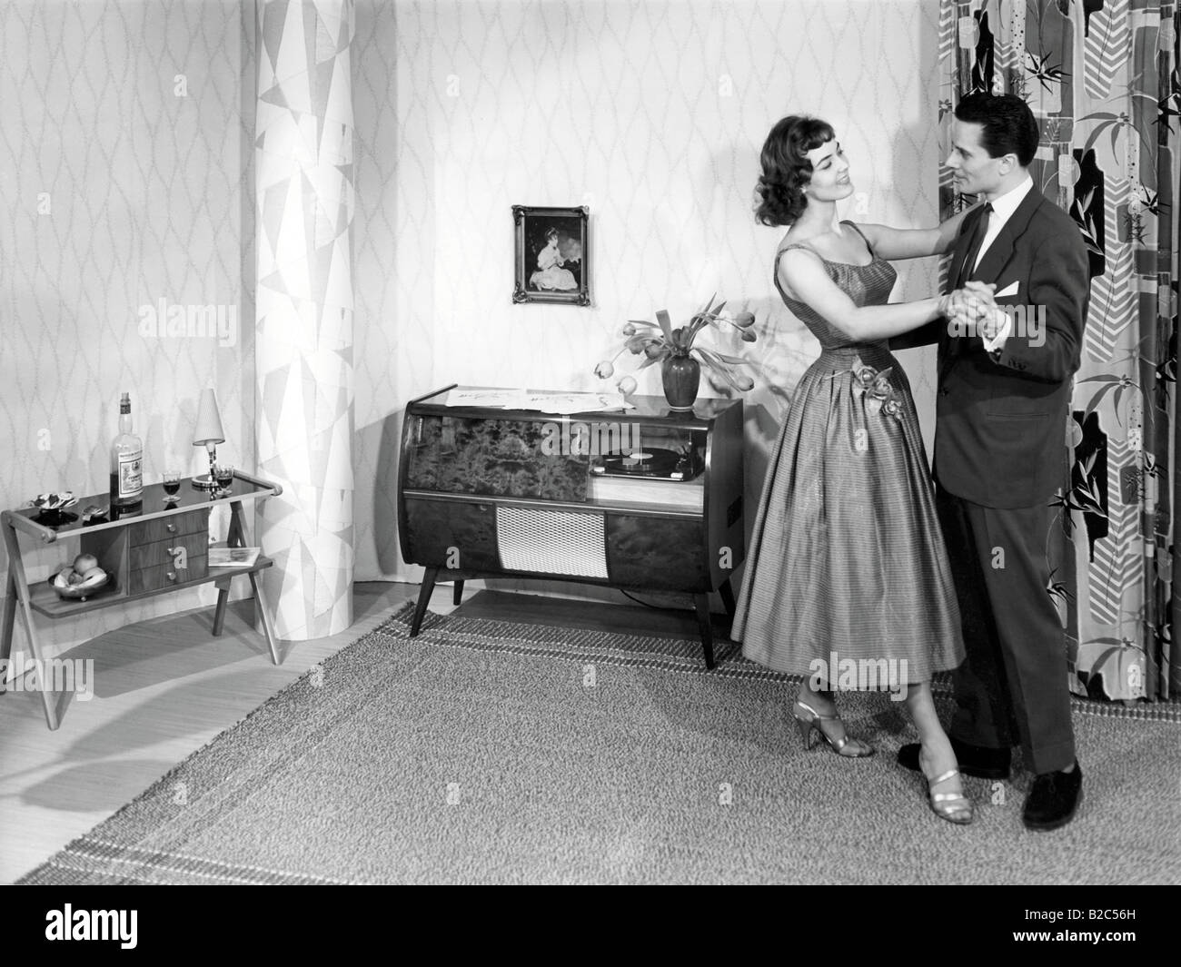 Couple dancing in the living room, historic picture from about 1955 Stock Photo