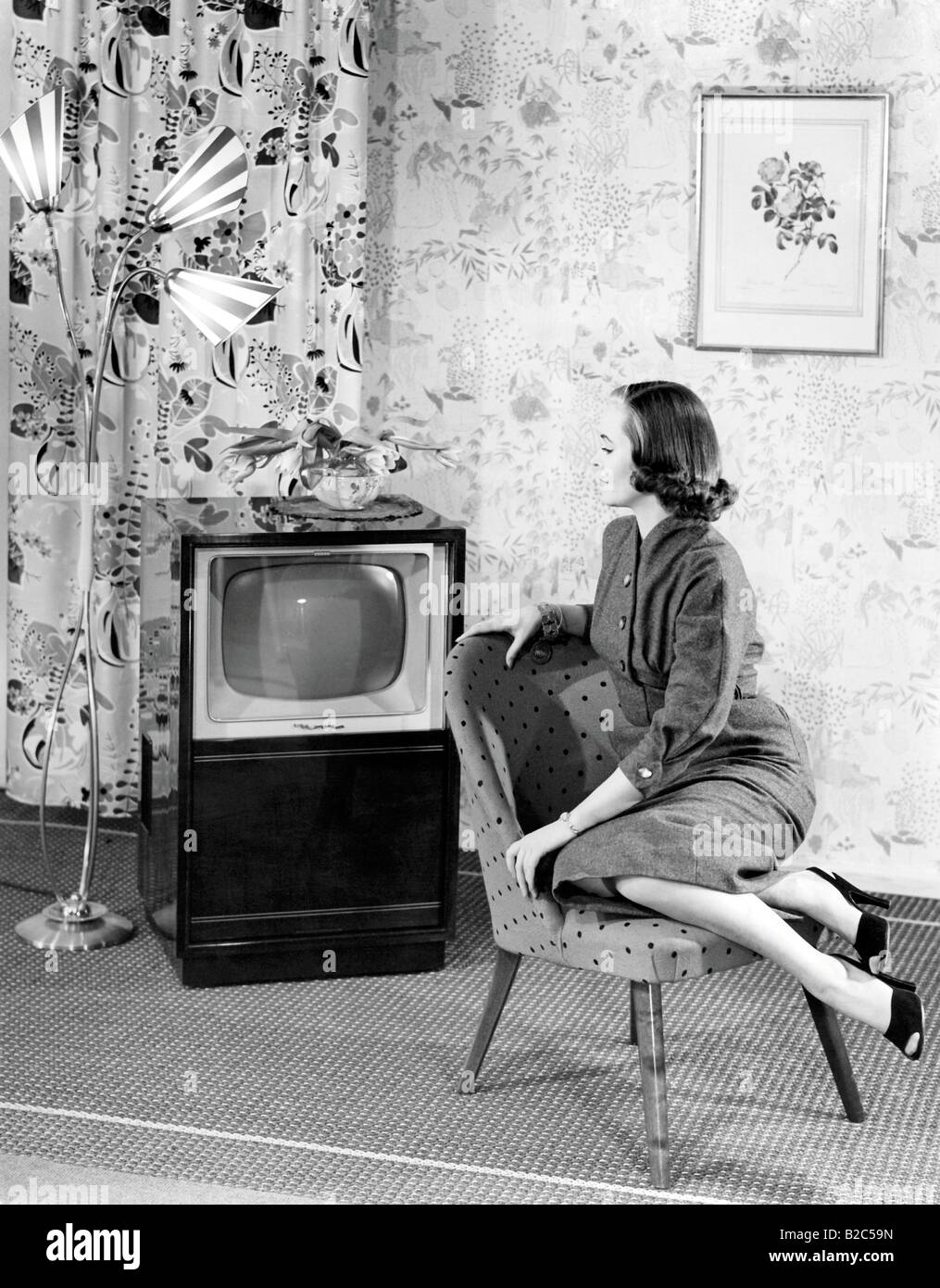 Woman posing next to a television, historic picture from about 1955 Stock Photo