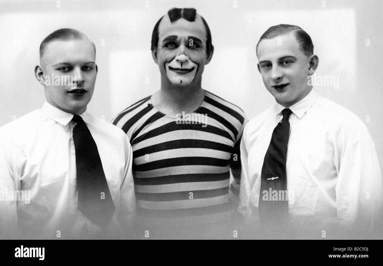 Clown between two men wearing lipstick, historic picture from about 1910 Stock Photo