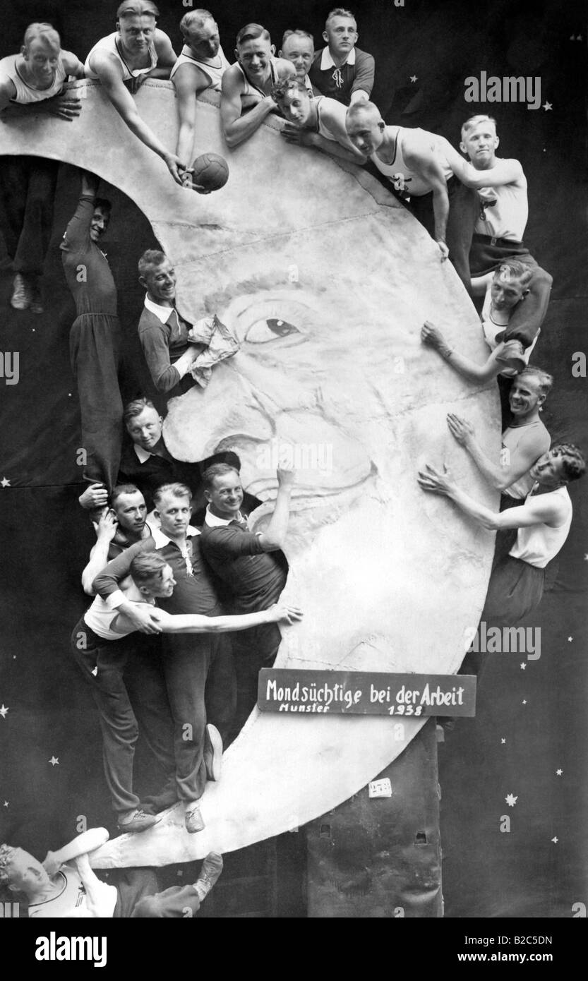 Moonstruck at work, men posing with a fake moon, historic picture from about 1938, Muenster Stock Photo