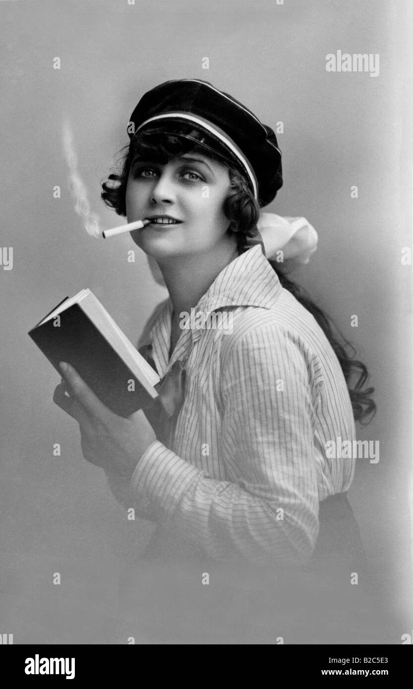 Modern youth, woman reading a book and smoking, historic picture from about 1910 Stock Photo