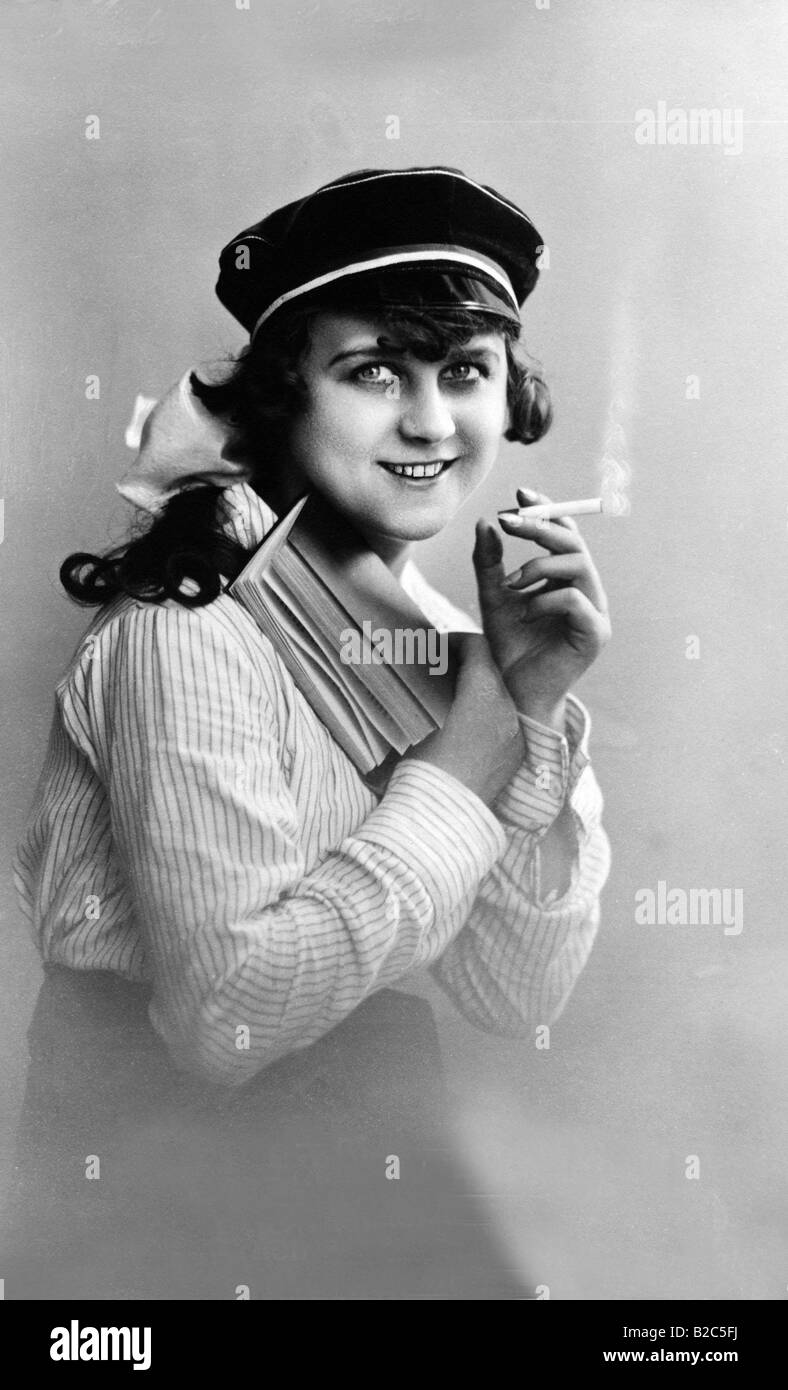 Modern youth, woman reading a book and smoking, historic picture from about 1910 Stock Photo