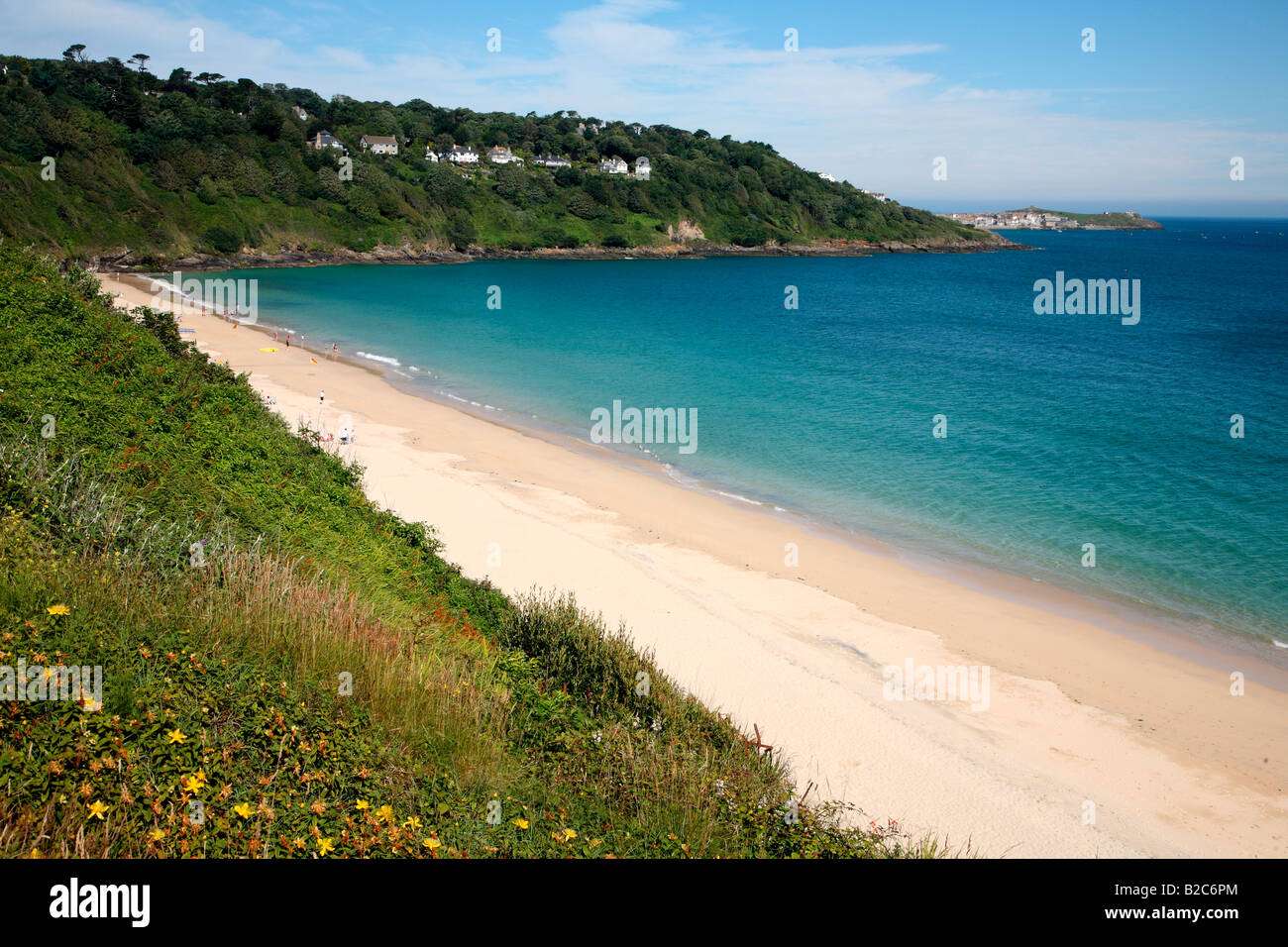 The beach at Carbis Bay in Cornwall UK with St. Ives in the distance. Stock Photo