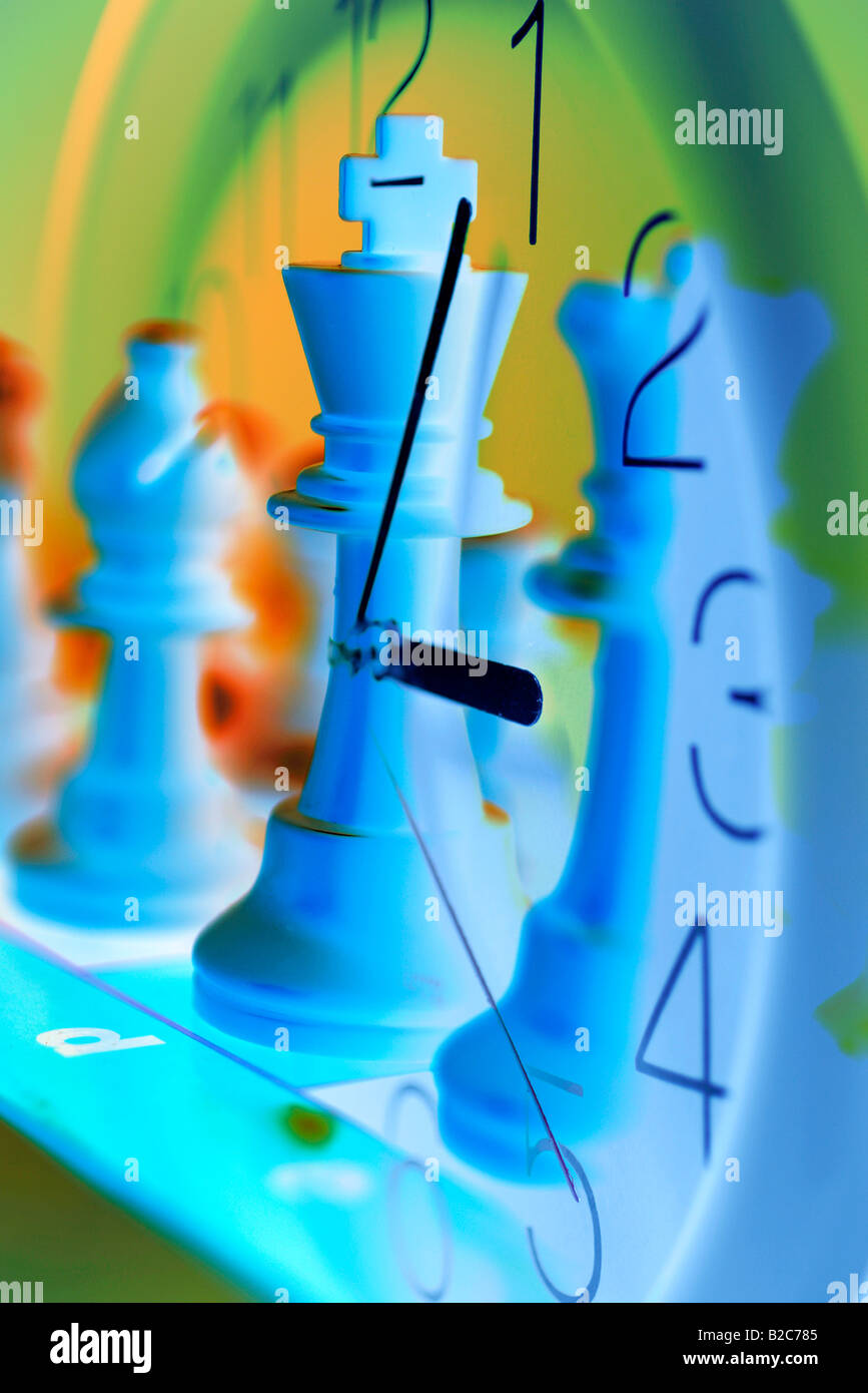 Composite of clock and chess figures Stock Photo