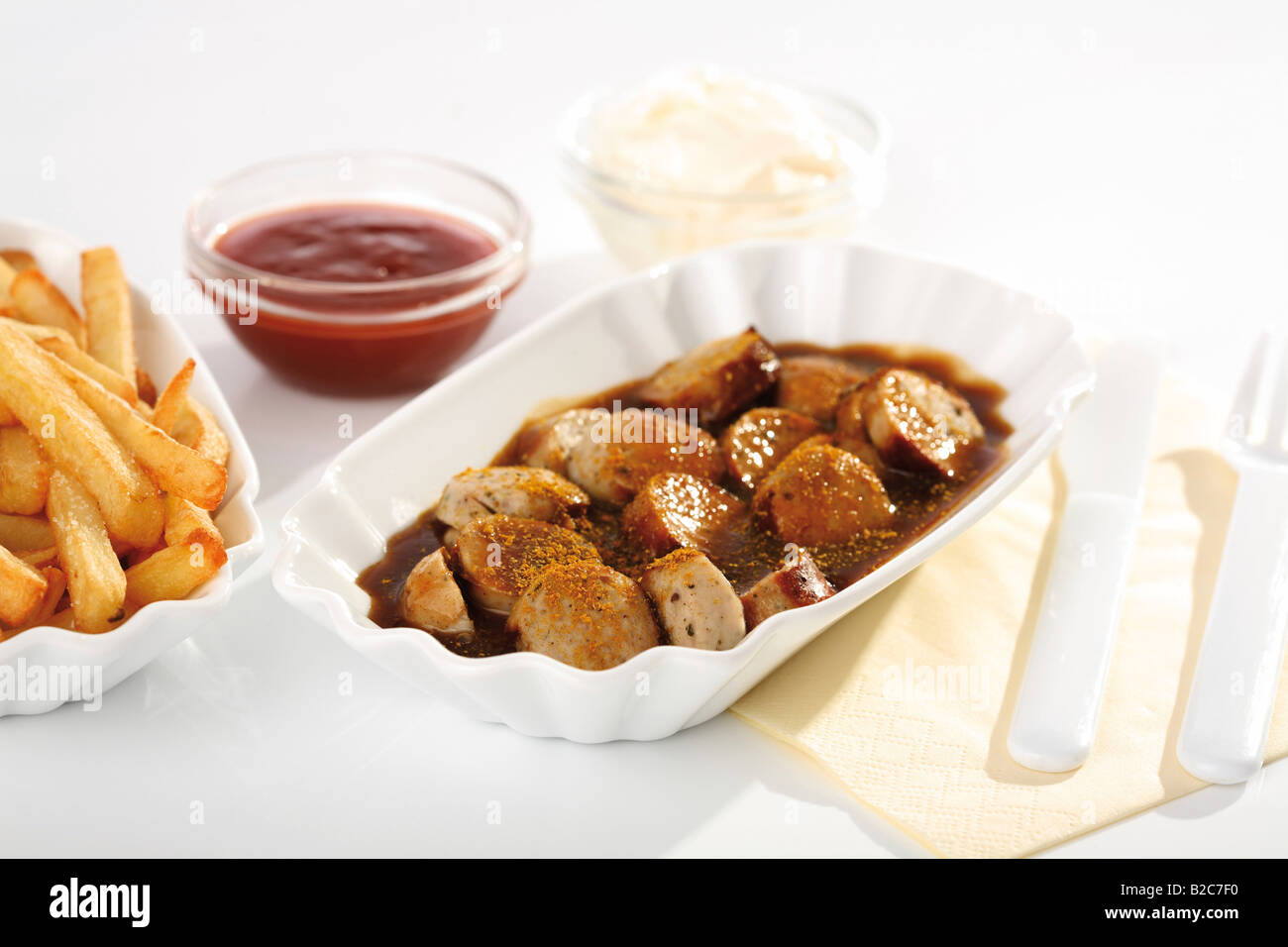 Curry sausage with chips, ketchup and mayonnaise Stock Photo Alamy