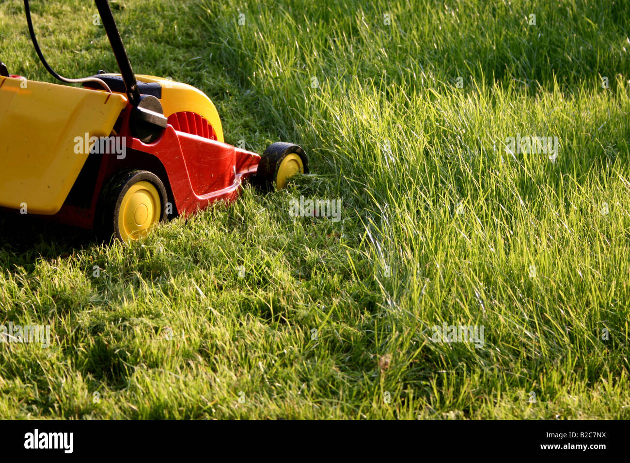 Lawn mower in a garden Stock Photo