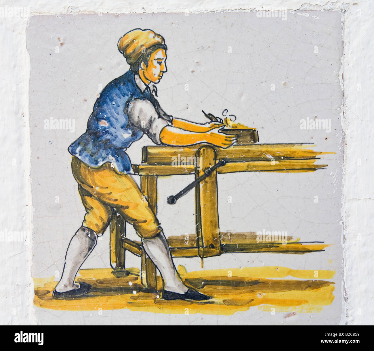 Copy of 18th century Spanish azulejo of carpenter at work Stock Photo