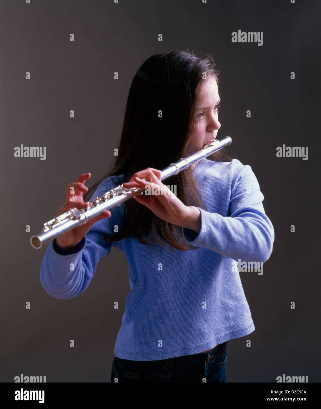 young girl playing the flute Stock Photo