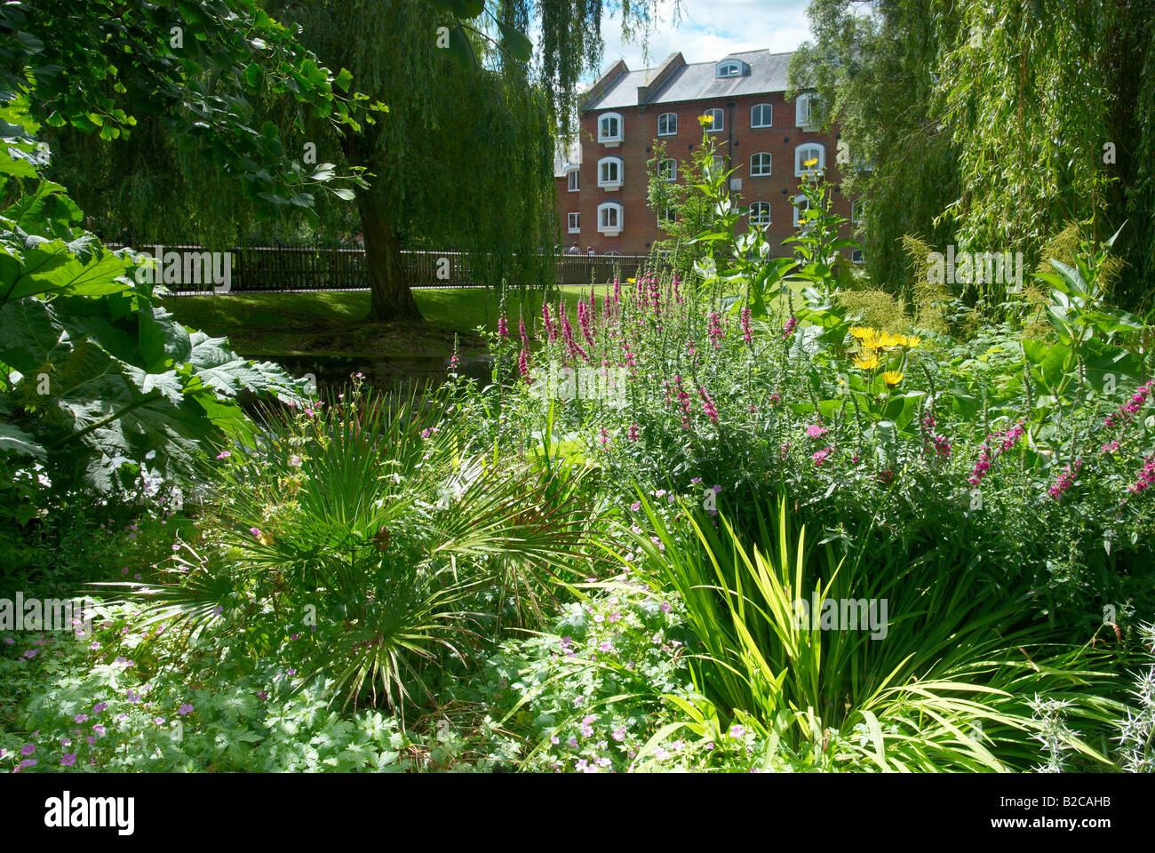 Public gardens along The Weirs in Winchester with Wharf Mill (now flats