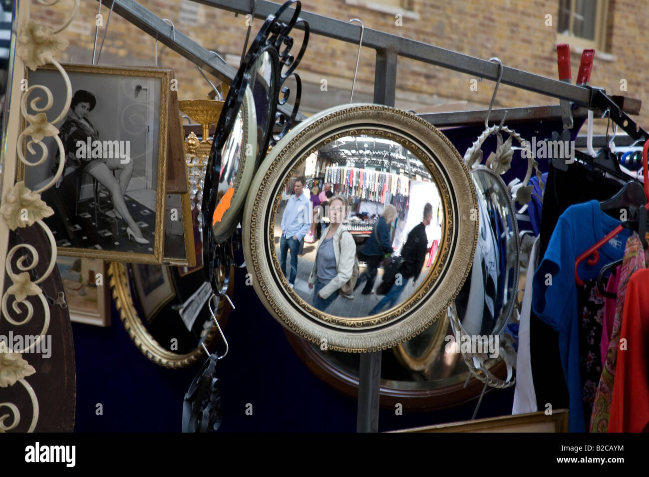 Convex mirror and reflection of girl on stall in Spittalfields indoor