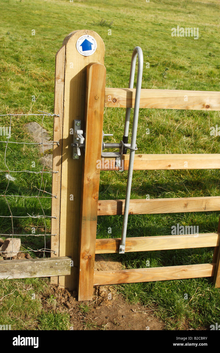 Gate opening mechanism and bridleway blue arrow sign on gate post in