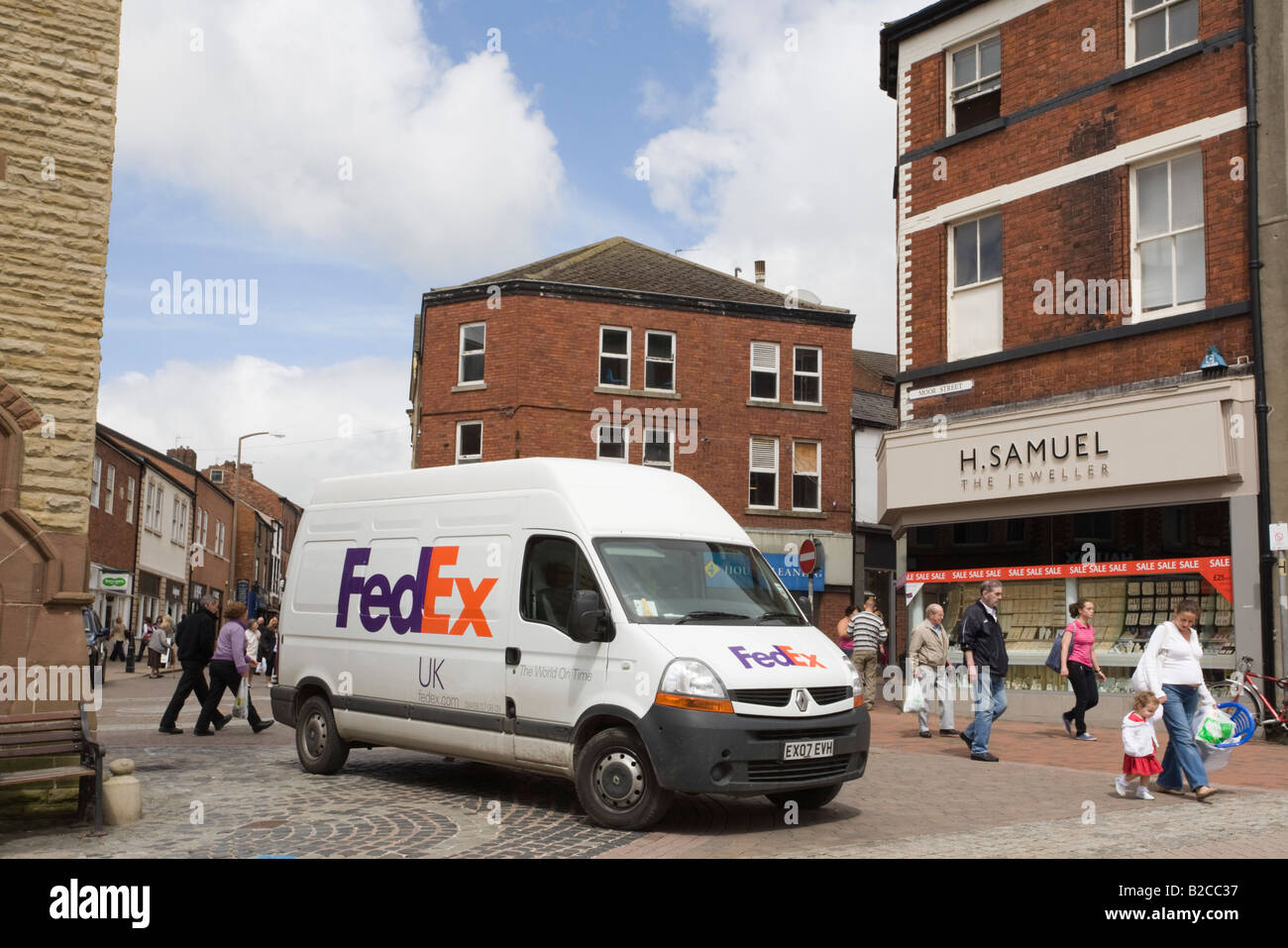 FedEx white delivery van on pedestrianised street in town shopping centre. Ormskirk Lancashire England UK Britain Stock Photo