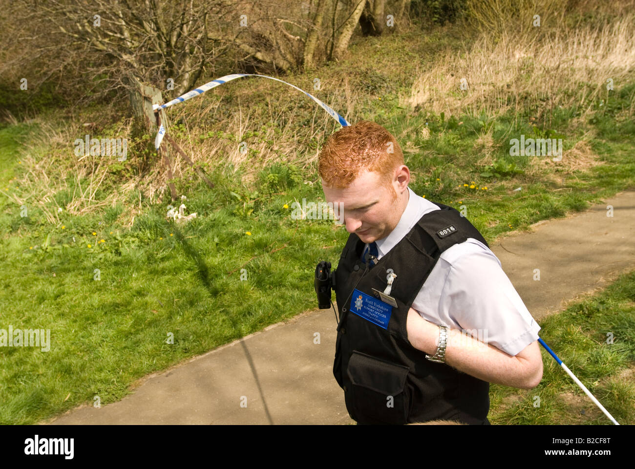 Police set up a security cordon for the underwater search team to look for a weapon used in a murder. Stock Photo