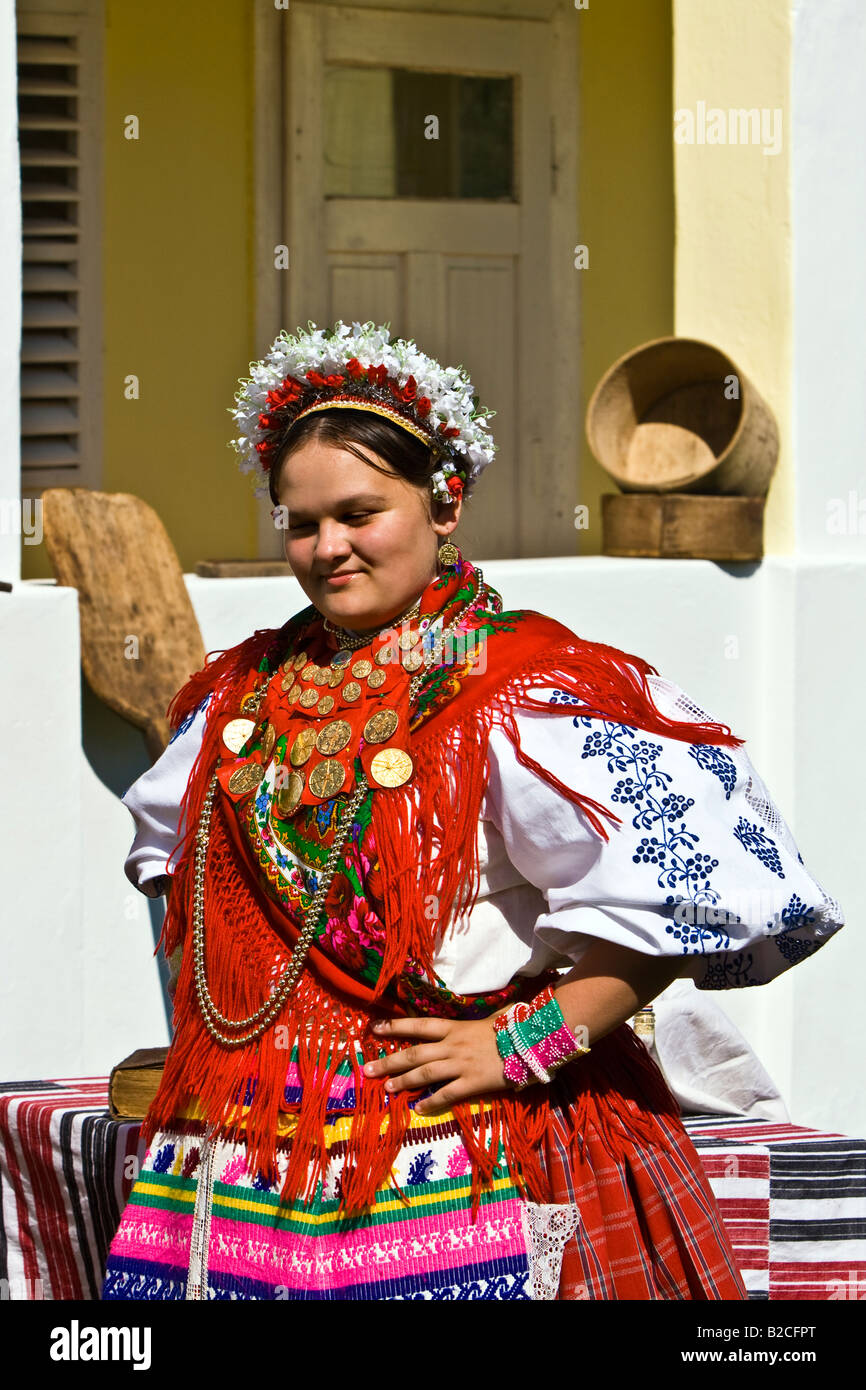 Girl in the Croatian traditional dress with ducats on the dress and headdress Stock Photo