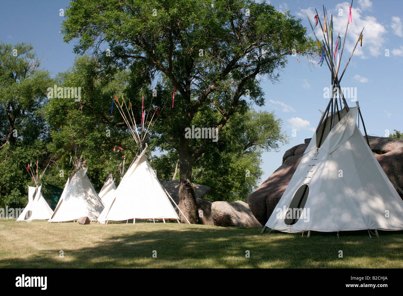 Indian Teepees beside the Three Maidens boulders Pipestone National Monument Stock Photo