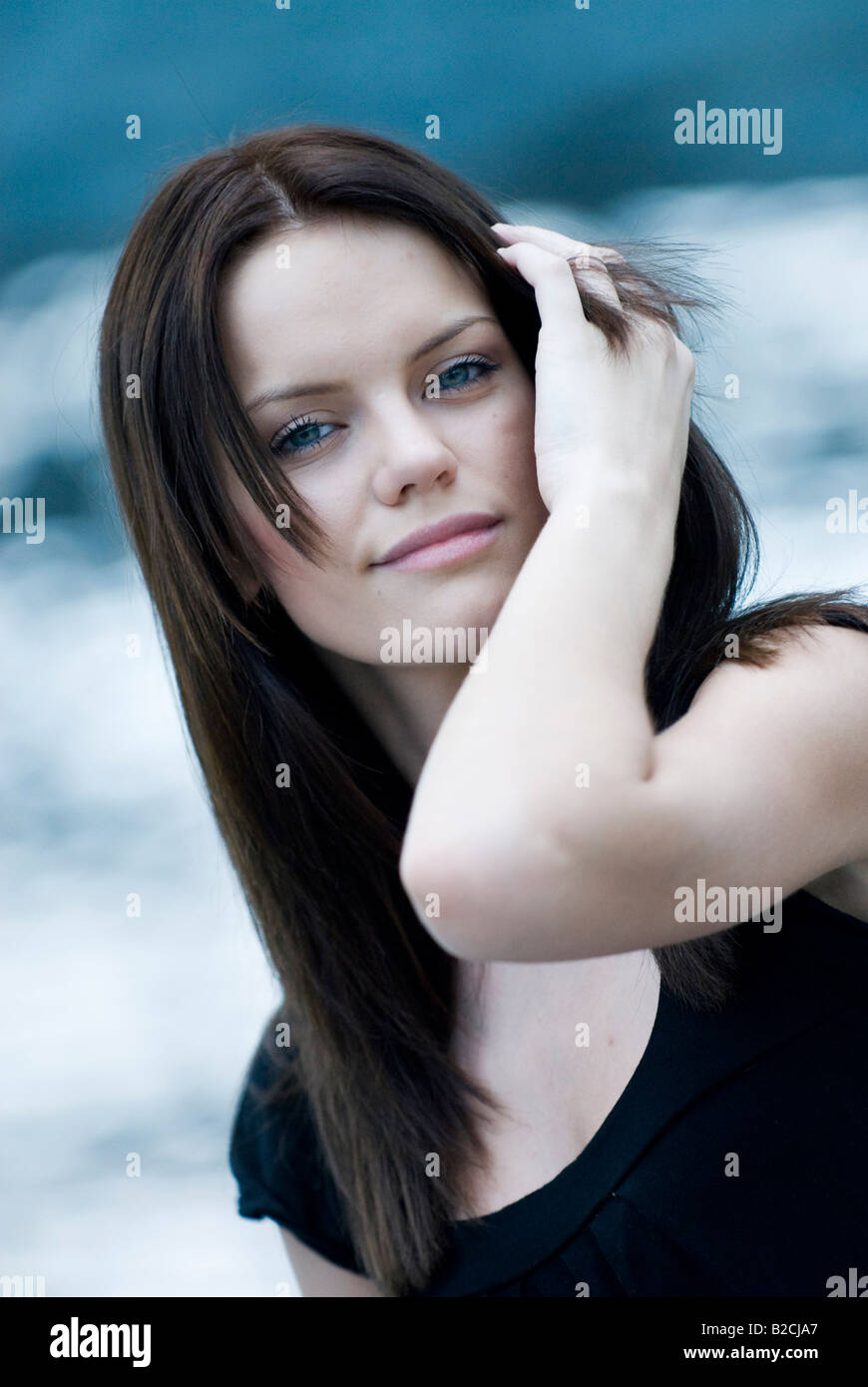 young woman grasping in her hair Stock Photo