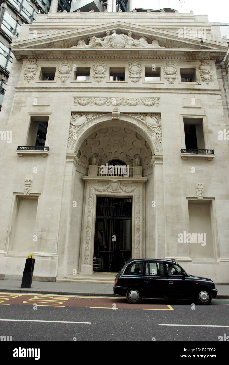 Lloyds of London old building entrance with taxi Stock Photo