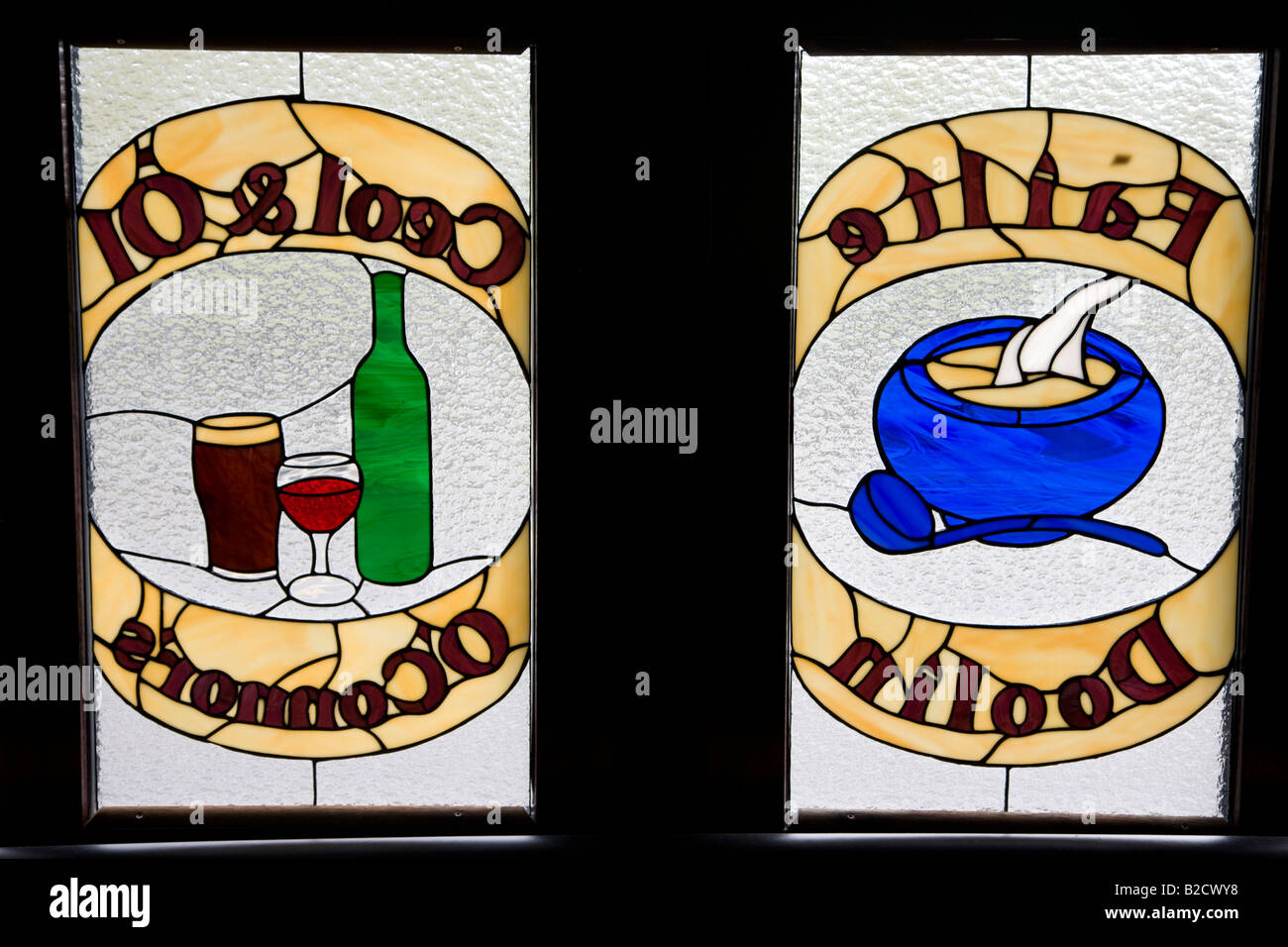 Stained glass signs on Irish pub window, Doolin County Clare, Ireland